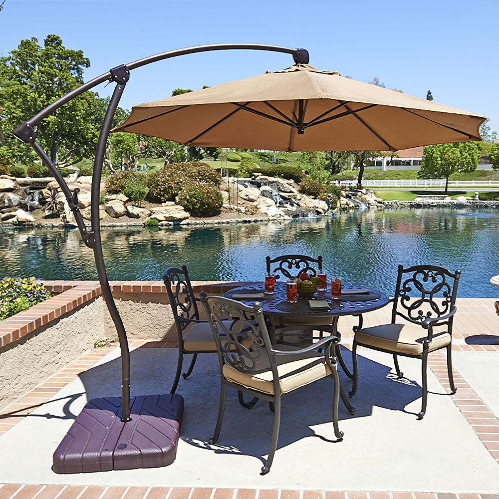 Image of the Bayside Series Cantilever Umbrella by California Umbrella, perfectly set to enhance a backyard reflecting the serene coastal lifestyle. This umbrella combines a large, tilting, and fully rotating canopy with the charm of bayside living, offering dynamic shade and protection while you enjoy the breeze. The smooth crank lift and dynamic side tilt mechanisms allow easy adjustment throughout the day, ensuring comfort from sunrise to sunset. Crafted with a durable aluminum construction and featuring a versatile 360-degree rotation, the Bayside Series embodies both elegance and practicality, ideal for creating a personal bayside retreat in any outdoor space.