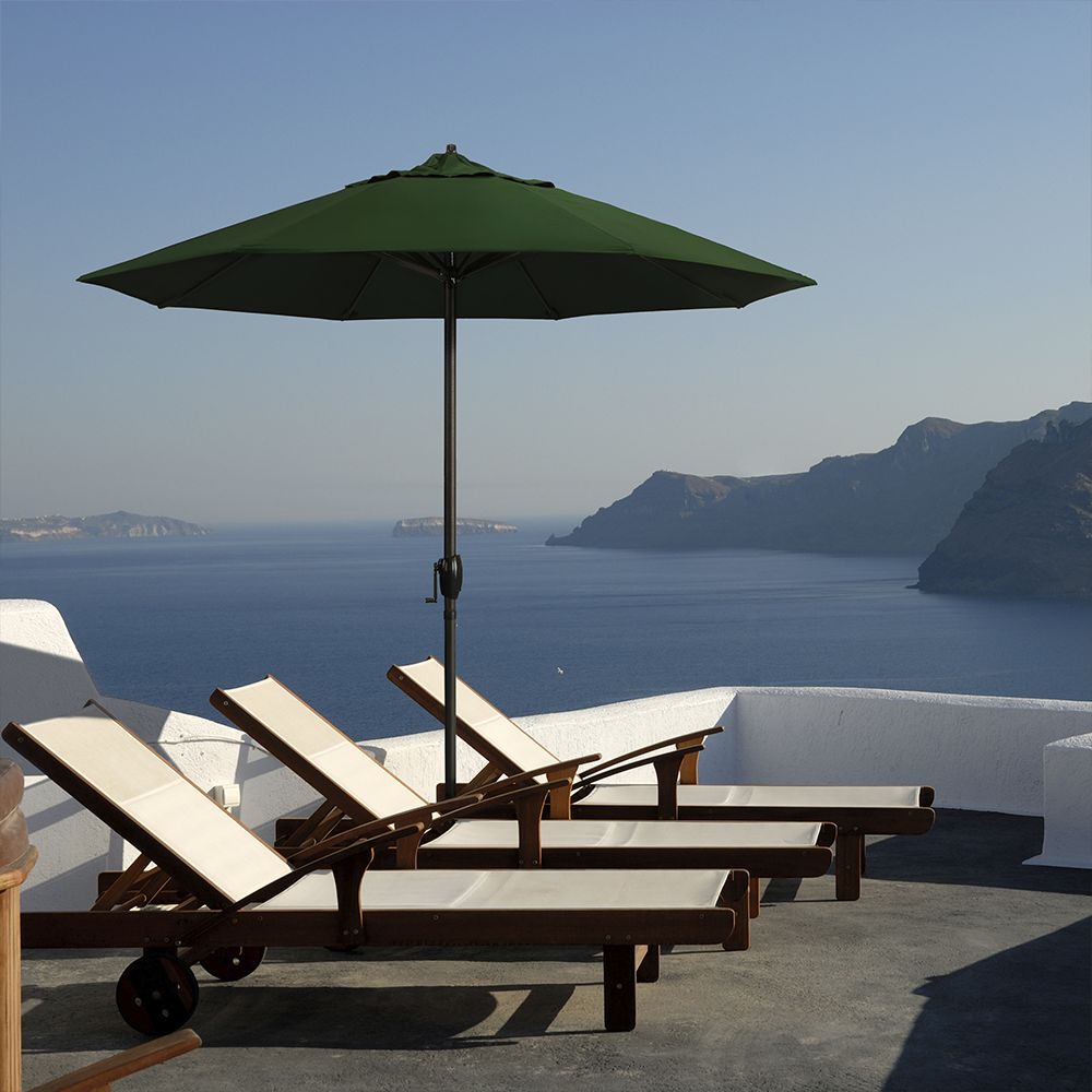 Image of the Casa Series Residential Patio Umbrella by California Umbrella, beautifully set in a serene garden, embodying the essence of California living. This umbrella features a sleek aluminum construction, highlighted by its durability and resistance to corrosion, perfect for outdoor relaxation. Equipped with an easy crank lift and seamless auto tilt, the Casa Series offers effortless shade adjustment, enhancing outdoor comfort and function. The reinforced aluminum ribs ensure reliable performance, making it an ideal addition for any patio that seeks to blend indoor comfort with outdoor ease.