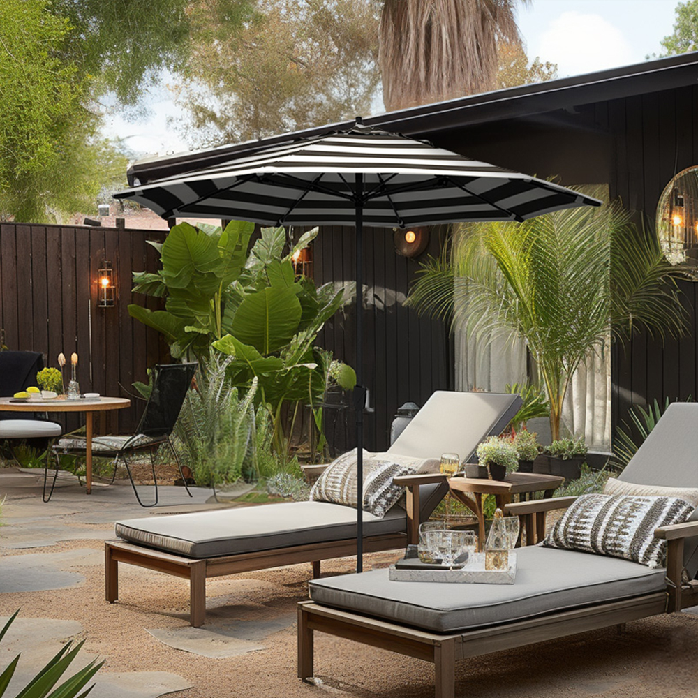 Image of the Vento Series Residential Patio Umbrella by California Umbrella, elegantly displayed in a coastal setting. Designed for coastal living, the umbrella showcases a sleek, modern design with a lightweight aluminum center pole and flexible fiberglass ribs, emphasizing both beauty and durability against the backdrop of sea breezes and ocean views. The easy crank lift and seamless auto tilt features are highlighted, demonstrating the umbrella's ease of use and robust construction, perfect for beachside patios or any outdoor space that resonates with the charm of the coast.