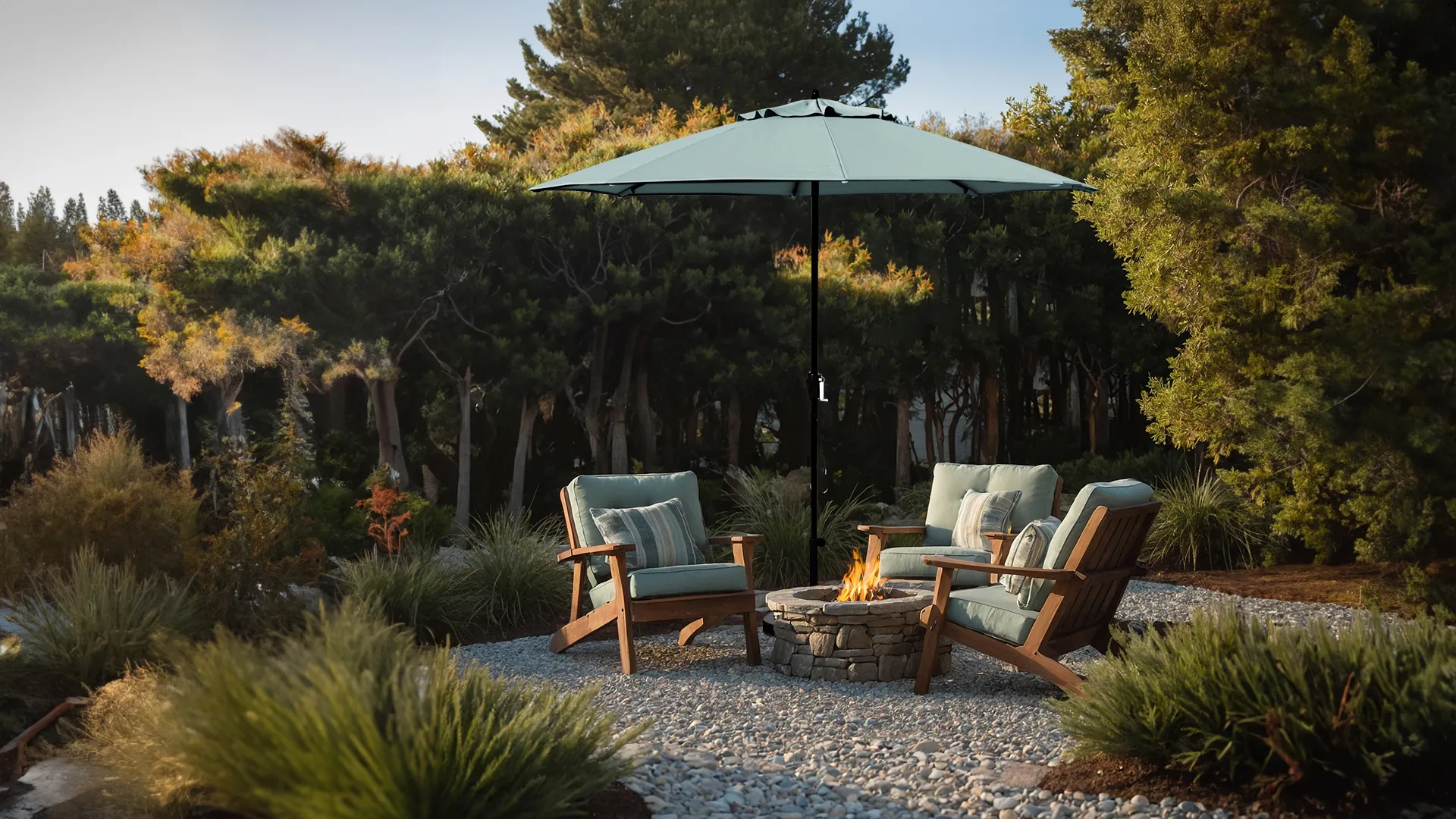 California Umbrella's residential grade Casa Series patio umbrella in Sunbrella Aruba fabric, showcasing a tranquil outdoor setting with two plush chairs around a fire pit, set against a backdrop of lush greenery and decorative gravel.