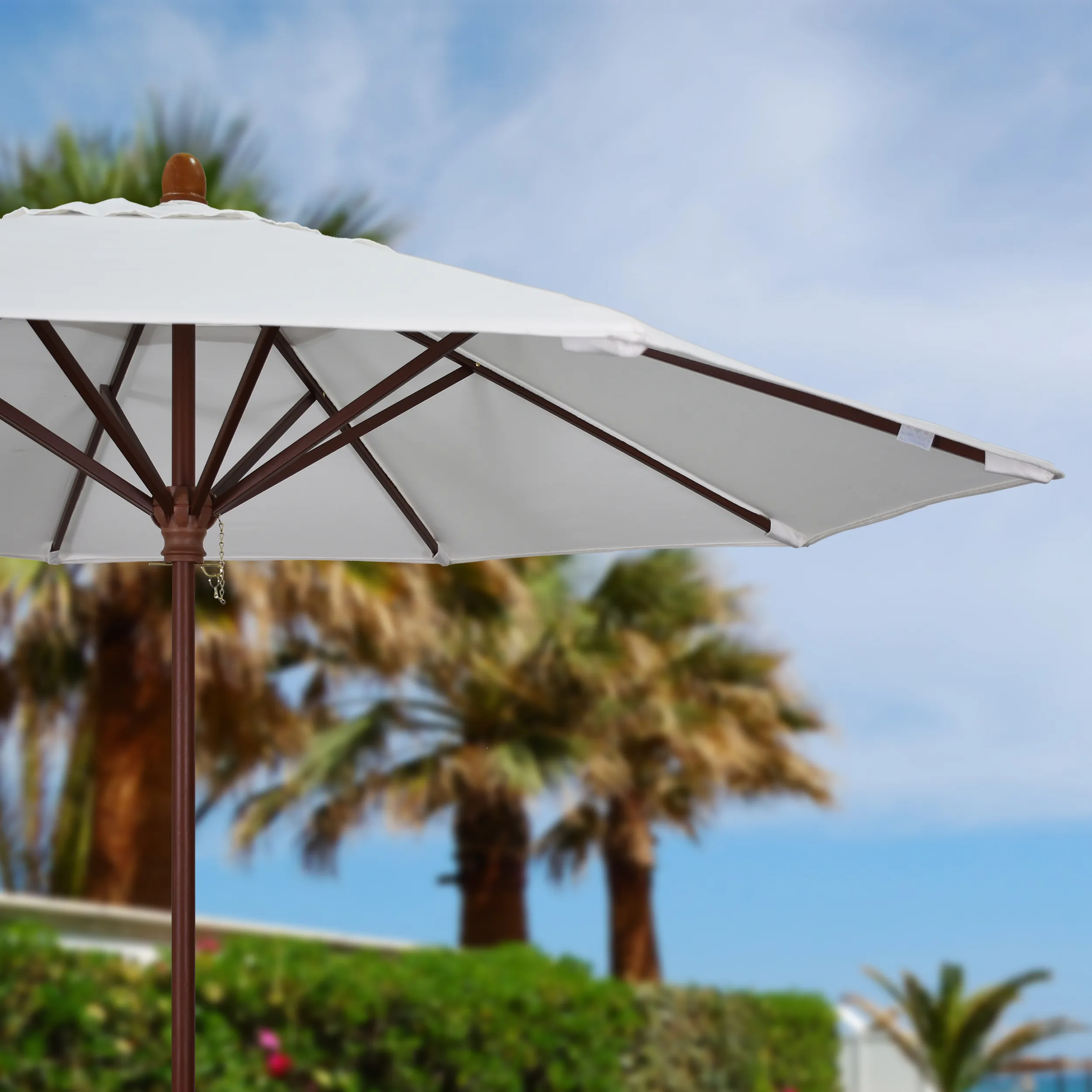 Showcasing the commercial-grade durability of the Grove Series patio umbrella by California Umbrella, featuring an all-wood frame and a sleek white canopy, perfect for upscale outdoor environments.