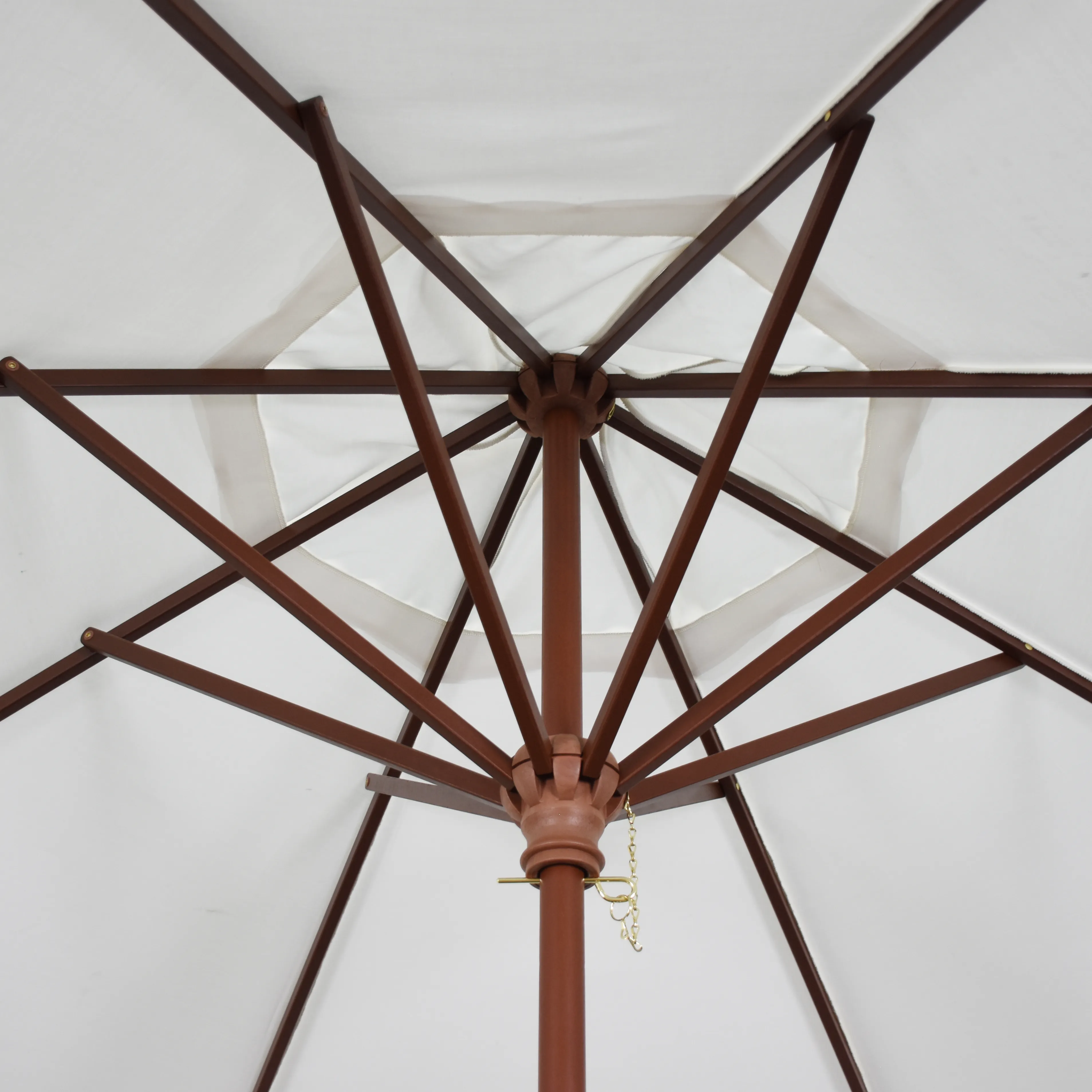 Close-up of the hardwood ribs on the Grove Series commercial patio umbrella by California Umbrella, featuring durable all-wood construction and elegant craftsmanship, paired with Sunbrella Natural color fabric for a sophisticated outdoor aesthetic.