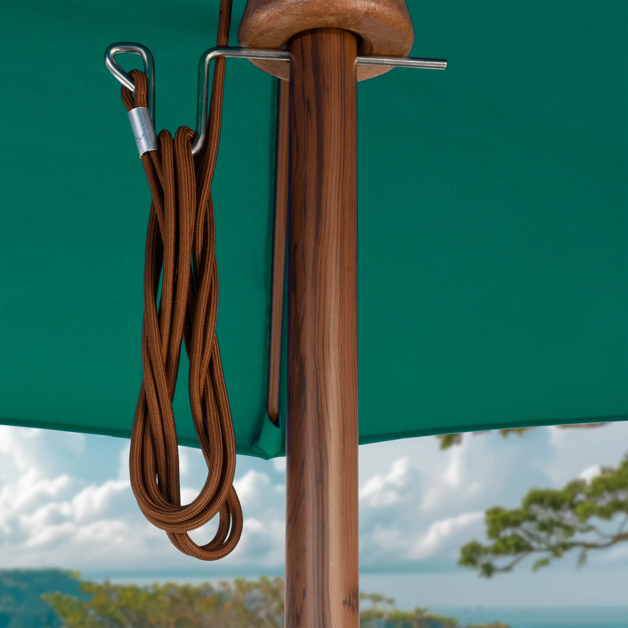 Close-up of the elegant wood finish pole and sturdy cord system on the Madera Series commercial-grade patio umbrellas by California Umbrella, highlighting craftsmanship and premium materials.