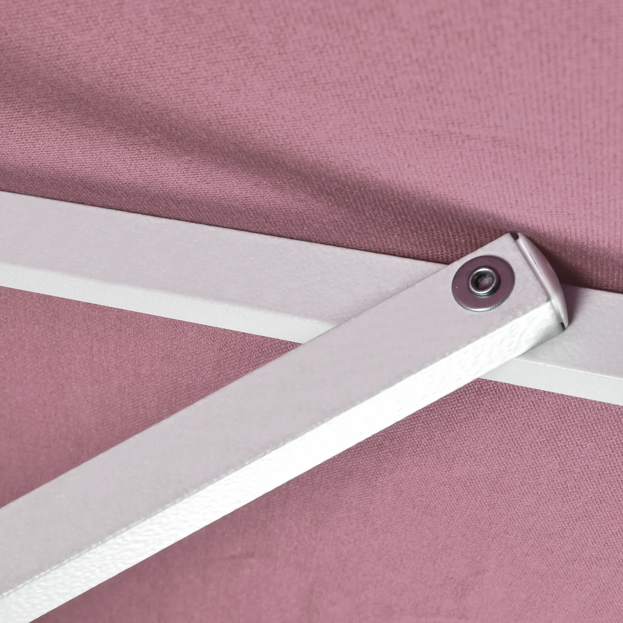 Close-up image of the reliable aluminum ribs of the Pacific Trail Series Patio Umbrella by California Umbrella, demonstrating their sturdy construction. The ribs are prominently featured against the backdrop of the umbrella's elegant, Sunbrella fabric in a deep rose hue. This detailed view highlights the robustness and precision engineering of the ribs, which provide essential support and flexibility to the canopy, ensuring it withstands various weather conditions and maintains its form and functionality.