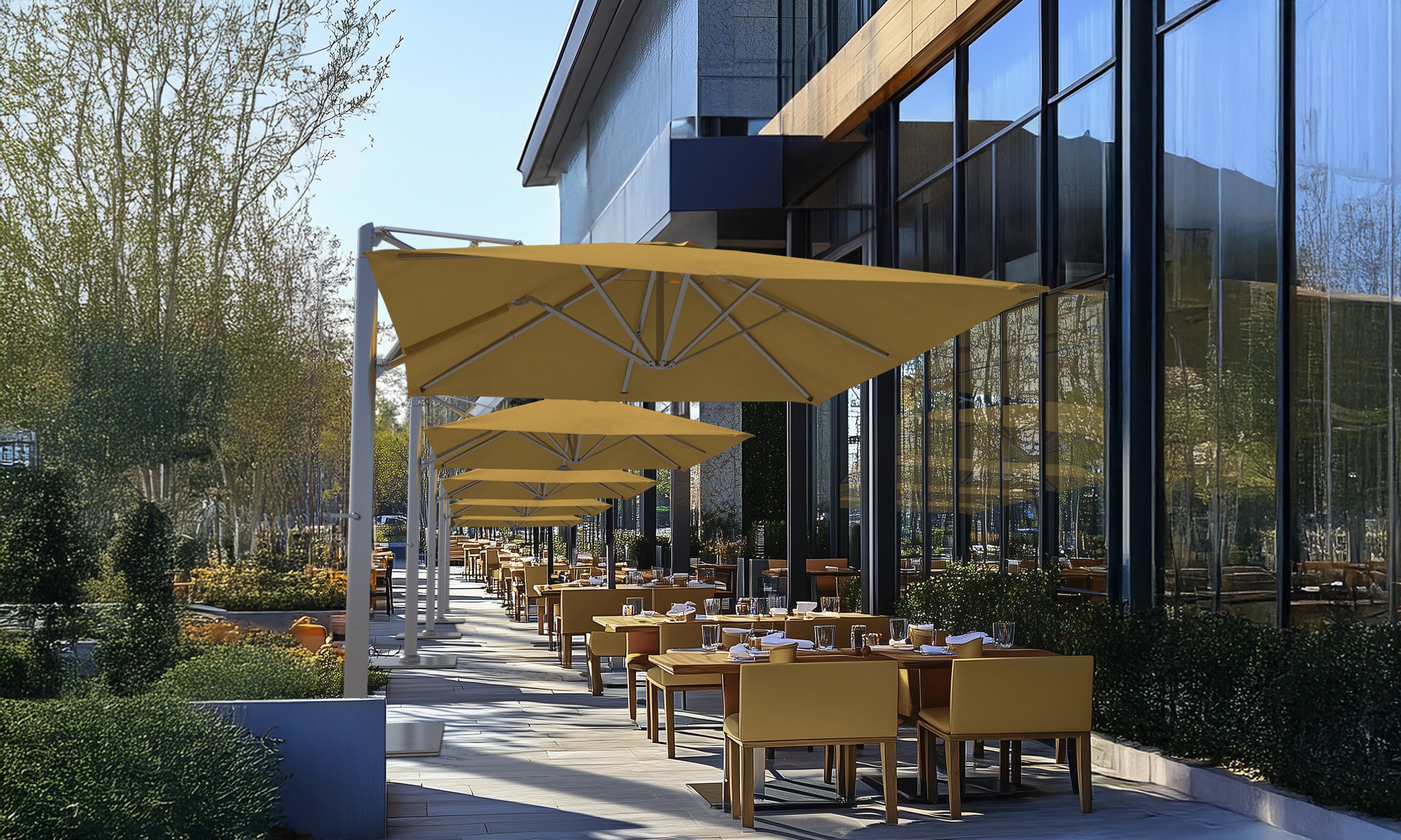Solana Series commercial patio umbrella with an aluminum center mast, crank lift, 360° rotation, and aluminum ribs with wind stabilizers, providing elegant shade over a luxurious poolside lounge at an upscale resort. This California umbrella enhances the setting with plush waterproof loungers and a stylish wooden side table with a refreshing drink, creating the perfect relaxation spot.