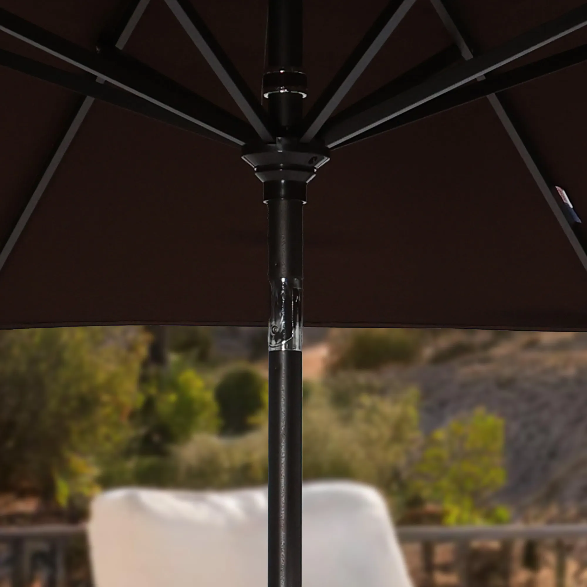 Image of the durable aluminum center pole of the Sunset Series Patio Umbrella, showcasing its robust and weather-resistant construction ideal for outdoor use. This pole provides a strong foundation, enhancing the umbrella's stability in various weather conditions.