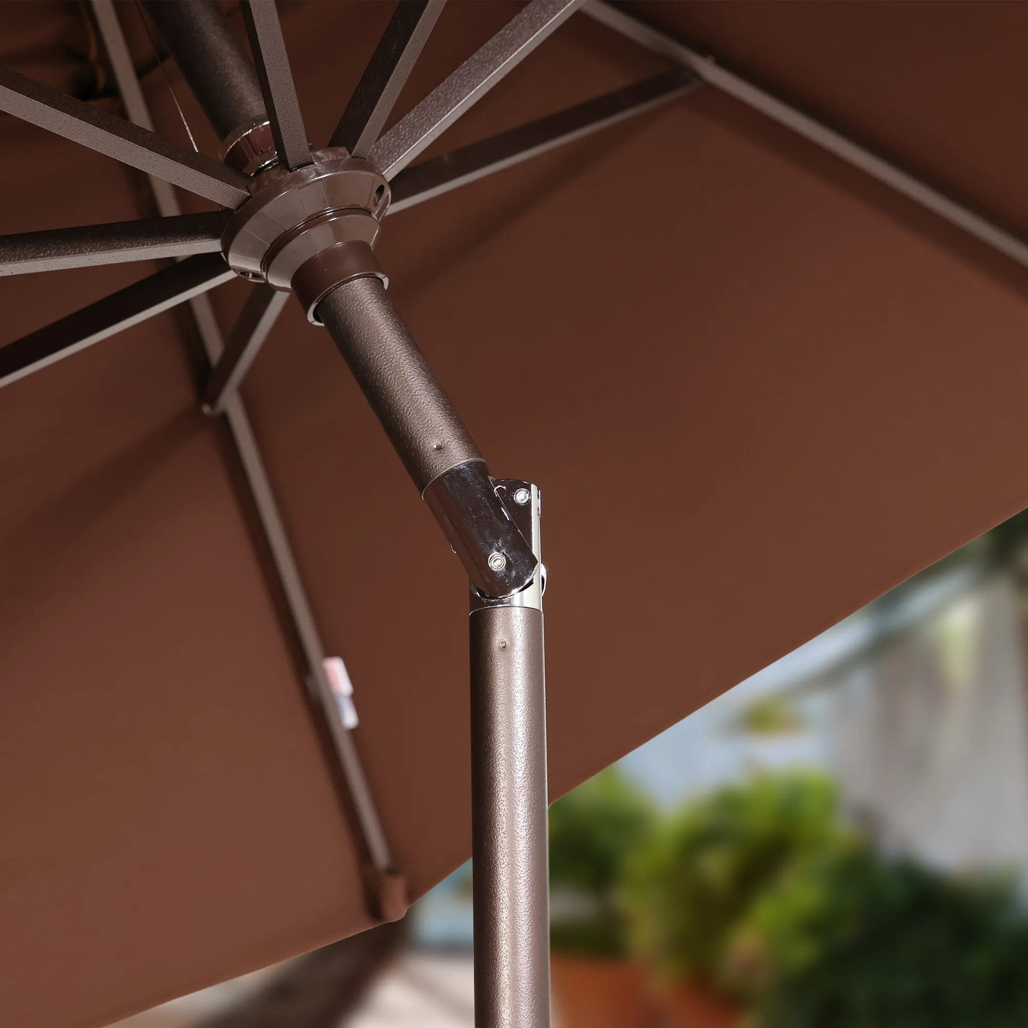 Image illustrating the seamless auto tilt feature of the Sunset Series Patio Umbrella, allowing for easy adjustment of the canopy to optimal angles for sun protection. This mechanism enables quick and effortless customization of shade areas as the sun's position changes.