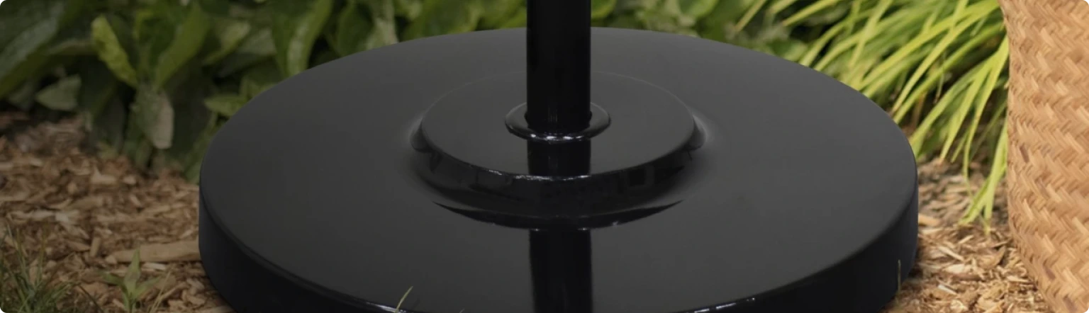 Heavy-duty black patio umbrella base providing sturdy support for commercial and residential umbrellas. Designed for durability and stability, this sleek umbrella stand ensures secure placement in outdoor spaces, complementing any patio, garden, or poolside setting.